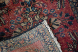 Vintage Lilihan rug corner showing cherry red pile, knot head wear, and hand-woven back.
