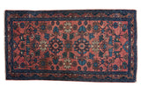 Hand-knotted Antique Persian Lilihan rug with blush red field, teal, and ivory repeating florals.