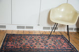 Antique Lilihan rug, blush red field, intricate teal and ivory floral pattern.