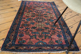 Intricate floral pattern on blush Persian Lilihan rug with teal and ivory details.