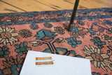Antique hand-knotted Lilihan rug with blush red field, intricate teal and ivory floral pattern.