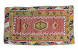 Vintage Turkish Kilim rug with blush red field, lime green central panel, and geometric patterns.