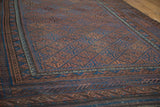 Intricate indigo and bronze gul motifs with germinating plant border on a late 19th-century Belouch rug.