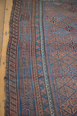 Reciprocating wave border and geometric gul motifs of an antique Belouch rug.