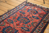 Distressed cranberry red and cobalt blue floral pattern of a Persian Dargezine rug.
