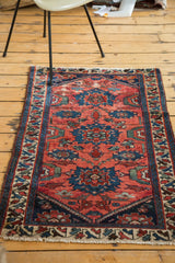 Antique Persian Dargezine rug with cranberry red and cobalt blue, showing areas of textural wear.