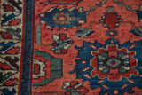 Antique Dargezine rug detail: cranberry red and cobalt blue sharp-edged floral design.