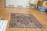 Distressed Malayer rug featuring abrash in cobalt blue, salmon, and dandelion yellow.