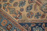 Close-up of distressed antique Persian Hamadan rug pile with indigo, teal, and beige motifs.