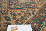 Textured pile of an antique Hamadan rug, featuring geometric patterns in blue, terra cotta, and beige.