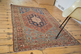 Time-softened tones and even wear on light blue and burnt orange Malayer rug patterns.