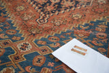 Detail of the antique Malayer rug, showing its storied texture and tribal patterns.