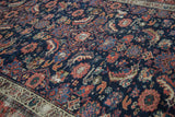 Herati and animal motifs on distressed antique Malayer rug, sapphire, blush, saffron tones.