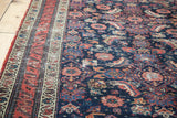 Patinaed red border and indigo field with complex Herati motif on a Persian Malayer rug.
