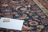 Distressed Malayer rug pile showing vibrant sapphire, emerald, and blush Herati motifs.
