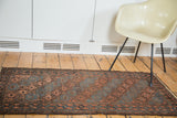 Antique Belouch rug runner, circa 1910's, featuring multi-paneled gul motifs in indigo, bronze, and chestnut.