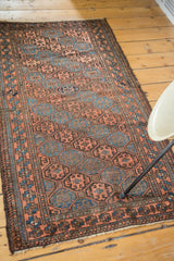 Antique Belouch runner: multi-paneled, diagonally oriented gul motifs in indigo, bronze, chestnut.