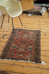 Distressed burgundy field and navy border of an antique Persian Lilihan rug.