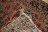 Antique Lilihan rug corner revealing distressed burgundy pile, fringe, and hand-knotted construction.