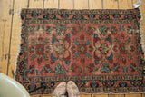 Whimsical distressed Lilihan rug showcasing faded burgundy and contrasting navy floral motifs.