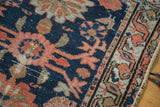 Antique Lilihan rug detail: distressed navy field, salmon and celadon floral border.
