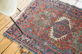 Geometric rectilinear patterns and distressed texture on this antique Karaja rug.