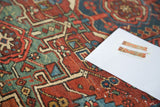Distressed antique Karaja rug with rectilinear geometric motifs in brick red, teal, and navy.
