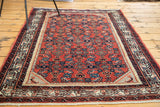 Vintage Engelas rug corner: soft cherry red field, beautiful azure and lavender border patterns, with fringe.