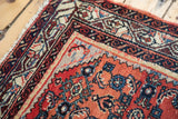Vintage Engelas rug corner with soft cherry red field and azure blue, lavender border.
