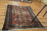 Distressed antique Lilihan rug with faded cranberry and celadon geometric patterns.