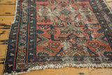 Distressed hand-knotted Lilihan rug with faded cranberry field, celadon patterns, and fringe.