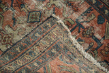 Folded corner distressed Lilihan rug, geometric border, short fringe.