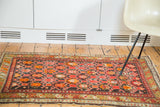 Vibrant early 20th century Caucasian rug with geometric tiger orange and crimson patterns.