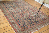 Worn herati motif on navy field, terra cotta and beige serbend borders of antique Malayer rug.