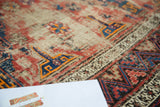Distressed antique Soumac rug texture, geometric patterns, cobalt blue, faded red, tangerine.