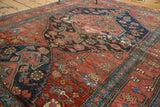 Distressed crimson red and navy blue fragmented pattern on the antique Halvaie Bijar rug.