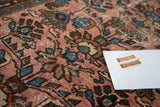 Distressed antique Lilihan rug showcasing faded raspberry field with softened blue and bronze motifs.
