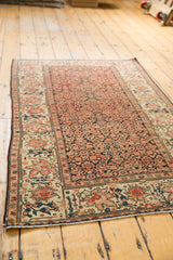 Antique Sarouk rug banded border with teal, terra cotta lotus, and herati motifs.