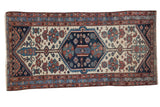 Distressed antique Hamadan runner rug with indigo hexagonal medallion, ivory field, and terra cotta floral motifs, 3'2