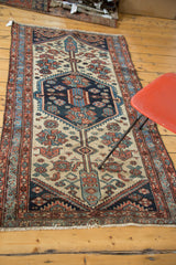 Distressed Persian Hamadan runner, lower end with geometric border and fringe details.