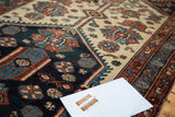 Intricate floral motifs and distressed texture of this antique Hamadan runner in indigo, ivory, and terra cotta.