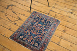 Distressed Persian Lilihan rug with navy field, vibrant peach and azure geometric pattern.