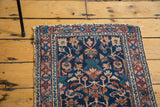 Distressed pile of the antique Lilihan rug, highlighting navy, azure, and coral tones.