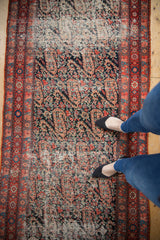Distressed antique Malayer runner texture, showing paisley motifs in navy, red, and cerulean blue.