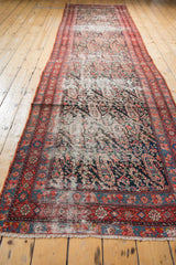 Malayer runner's distressed paisley field contrasting with vibrant candy red and cerulean blue borders.