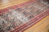 Textured distress on an antique Malayer runner's dark blue field with cerulean and red paisley.