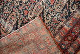 Distressed Persian Malayer rug pile with cerulean and red paisley, showing hand-knotted back.