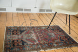 Distressed Lilihan rug corner, showing worn floral geometric patterns, fuchsia, seafoam, blue hues.
