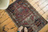 Distressed Persian Lilihan rug with vibrant floral-geometric motifs in fuchsia, seafoam, royal blue.