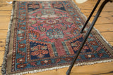 Antique Lilihan rug's distressed pile, highlighting fuchsia, seafoam green, and royal blue.